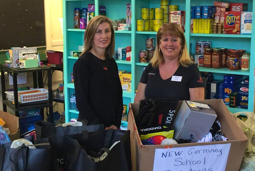 
Bridgewater Sport Chek store general manager Jennifer Milbury (left) makes a donation for the clothing, food and essentials locker and free store to Angela Gladwin, principal of the New Germany Elementary School. (Contributed)
