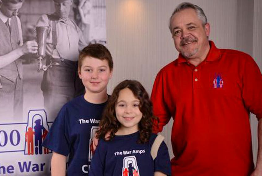 
Rob Larman (centre) with members of The War Amps Child Amputee (CHAMP) Program. - Contributed
