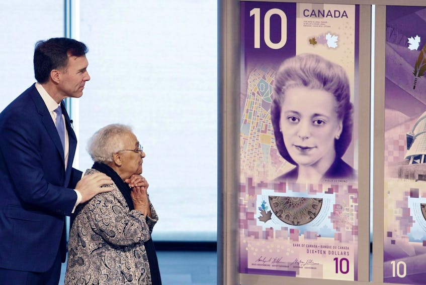 
With federal Finance Minister Bill Morneau, Wanda Robson, sister of Viola Desmond, unveils the new $10 bill that comes into circulation this week. The bill features Viola Desmond, a black Nova Scotian businesswoman who challenged racial segregation at a film theatre in New Glasgow, Nova Scotia, in 1946. - Eric Wynne / File
