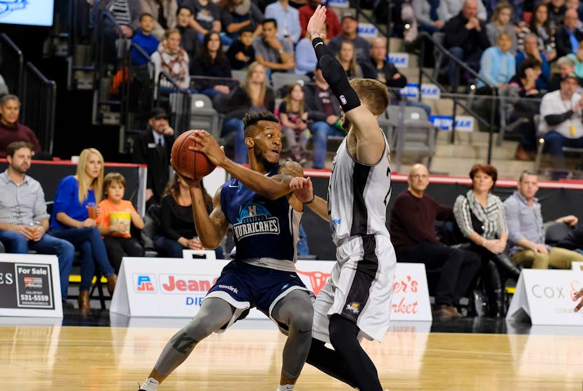 
Halifax Hurricanes guard Joel Kindred tries to drive against Moncton Magic forward Wayne McCullough during Saturday’s National Basketball League of Canada game in Moncton. (Mathieu Chiasson)
