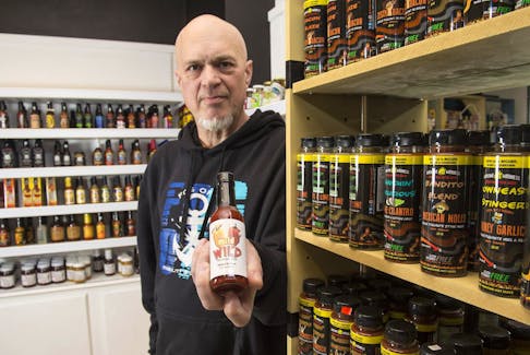 
David Jobe poses for a photo inside his new Mild to Wild Hot Sauce Shop inside Spring Garden Place on Monday. - Ryan Taplin

