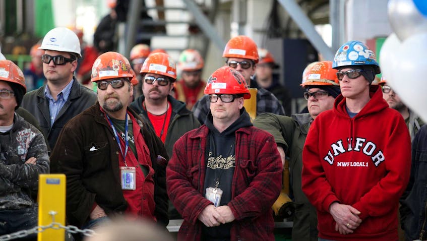 Shipyard workers watch the 2015 announcement at the Irving facility concerning the awarding of the build contract for the construction of six Arctic Offshore Patrol Ships to Irving Shipbuilding.