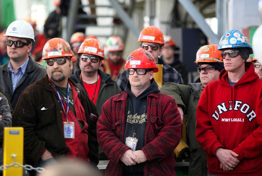 Shipyard workers watch the 2015 announcement at the Irving facility concerning the awarding of the build contract for the construction of six Arctic Offshore Patrol Ships to Irving Shipbuilding.
