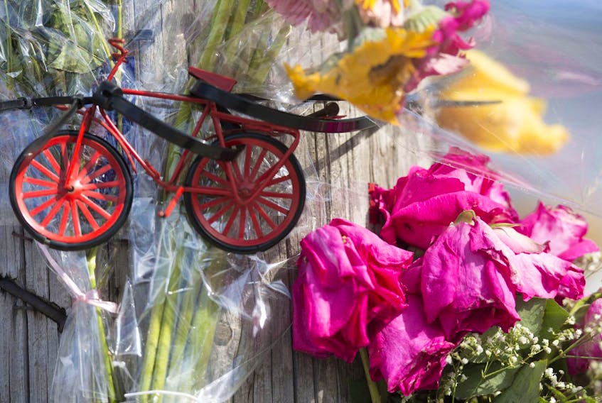 
A makeshift memorial to cyclist Johanna Dean on a telephone pole at the intersection of Windmill and Albro Lake Roads is shown in this 2014 file photo. - File


