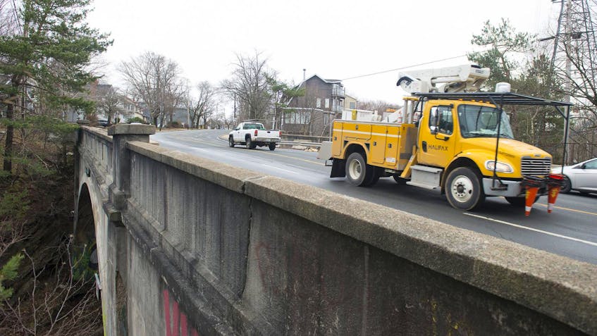 
Vehicles pass over the railway bridge on a road in Halifax on Friday morning. CN is proposing to put a temporary bridge in place while the current bridge is repaired. (RYAN TAPLIN/ STAFF)
