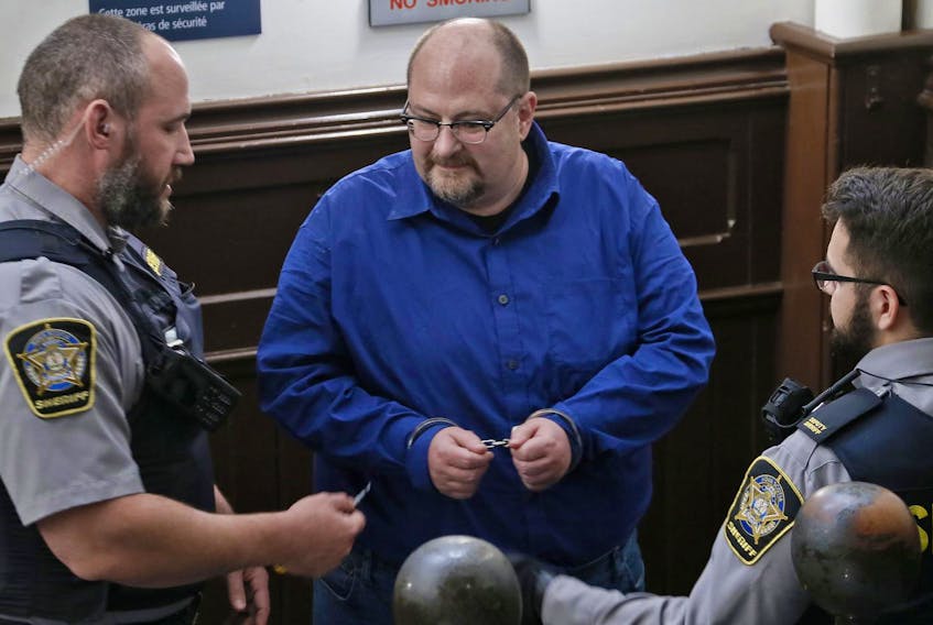 
Prominent trade unionist Tony Tracy prepares to have his handcuffs removed before being arraigned in Halifax provincial court Monday. Tracy was one of six people charged with mischief and obstructing police during a demonstration Sunday evening at Canada Post’s sorting facility on Almon Street. - Tim Krochak
