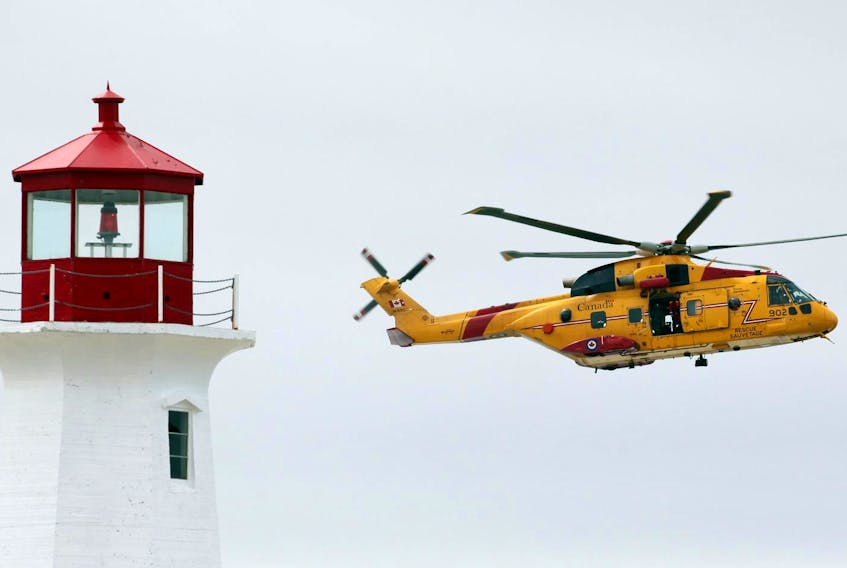
A coast guard Cormorant helicopter passes by the Peggys Cove lighthouse in 2015. 

