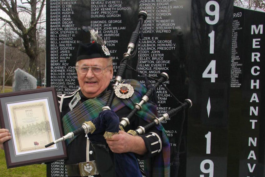 
Piper Ron LeBlanc proudly holds his commemorative plaque from the College of Piping in Scotland in recognition for his participation in the Battles Over Tribute on Nov. 11. - Dan Hennessey
