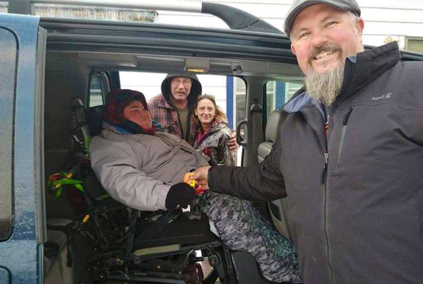 
Shane MacDougall arrived at Port Hawkesbury on Monday to deliver a wheelchair van to John-Michael Kennedy’s doorstep free of charge. They’re shown with John Michael’s father John F. Kennedy and stepmom Alice Vanee. - Contributed
