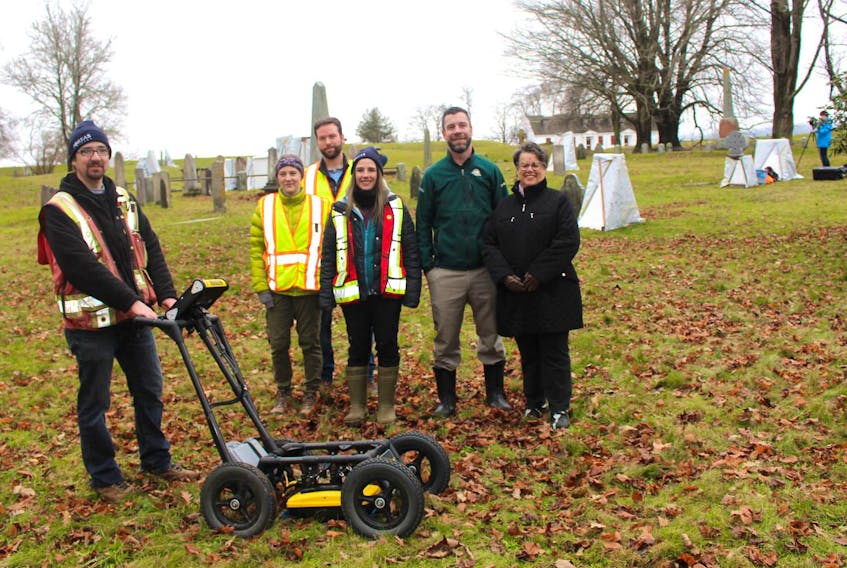 
From left: Boreas Heritage Consulting Inc. (BHC) co-founder Steve Garcin with the Applied Geomatics Research Group’s Sam Lewis and Nathan Crowell, Sara Beanlands (BHC), Ted Dolan (Parks Canada) and Heather LeBlanc (Mapannapolis) on the grounds of the Garrison Graveyard at the Fort Anne National Historic Site in Annapolis Royal on Monday, Dec. 3. (Heather Desveaux)
