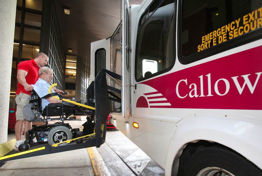 A Callow bus driver helps a man onto a bus outside Camp Hill Veterans’ Memorial hospital in 2012. The non-profit will end its busing service at the end of this year.  
