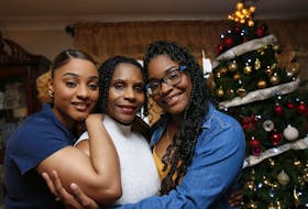 
Reeny Smith, left, with mother Maureen and sister Mahalia in their home Wednesday. - Tim Krochak
