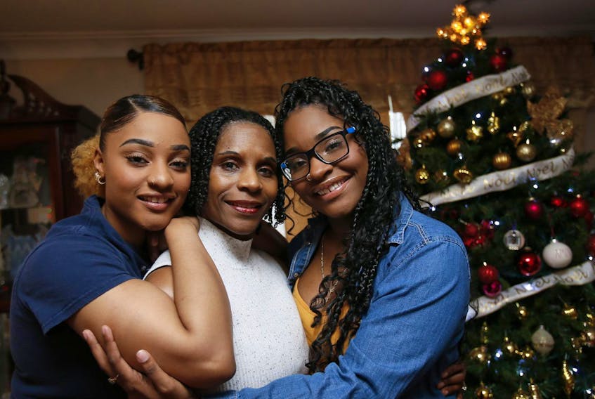 
Reeny Smith, left, with mother Maureen and sister Mahalia in their home Wednesday. - Tim Krochak
