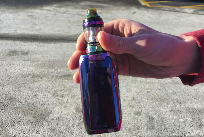 
A teen holds a vaping device. - Stuart Peddle
