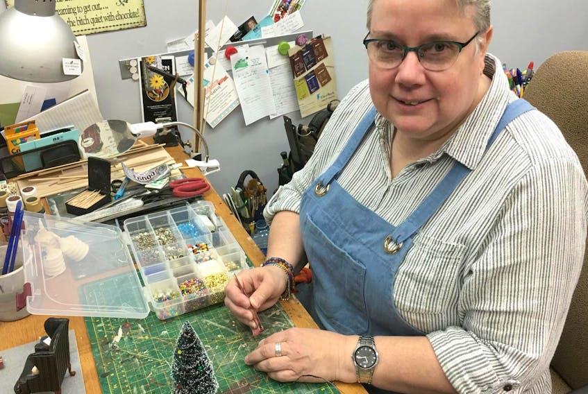 
Shelley Acker plays with a Christmas scene in her Kentville studio, gallery and retail store called Freedom Miniatures. - Heather Desveaux
