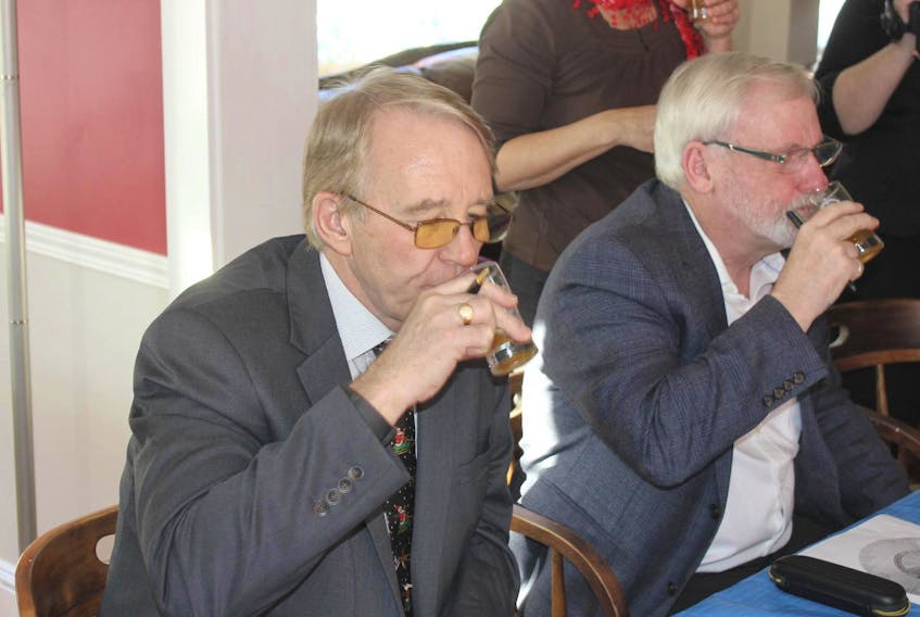 
Acadia University president Peter Ricketts (left) and Kings South MLA Keith Irving taste test a beer made by Saltbox Brewing using wild Nova Scotia yeasts collected and cultivated by Acadia researchers. - Ian Fairclough
