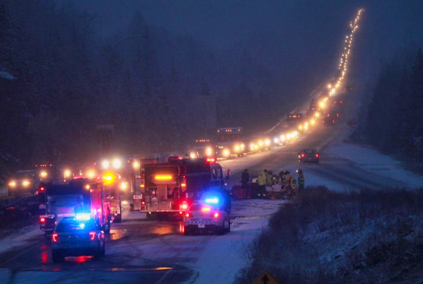 
Emergency personnel work at the scene of a crash on Highway 107 near Exit 18 on Tuesday morning. - Tim Krochak 
