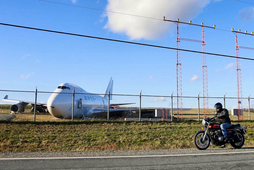 
A motorcyclist stopps to examine a Skylease Cargo Boeing 747-400 after it went off the end of Runway 14 at Halifax Stanfield International Airport Wednesday November 7, 2018. - Tim Krochak
