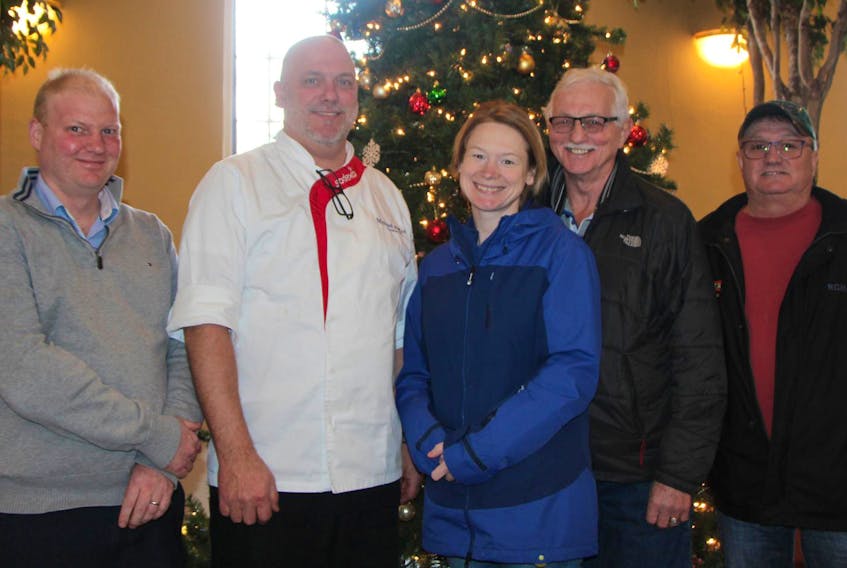 
One of the keys each year to a successful Christmas Day community dinner at St. James United Church Hall in Antigonish is the contribution of Sodexho Food Services at St. F.X. Chef Michael Pollock (second, left) and kitchen staff members cook the main course – turkeys – along with stuffing and gravy, for the celebration. Sodexho general manager Tim Hierlihy (left), Pollock and dinner co-ordinator Natasha AlAwashez, along with event volunteers Connie Beaton and Derek Bower, gathered recently to plan for delivery of the birds to Morrison Hall. - Corey LeBlanc

