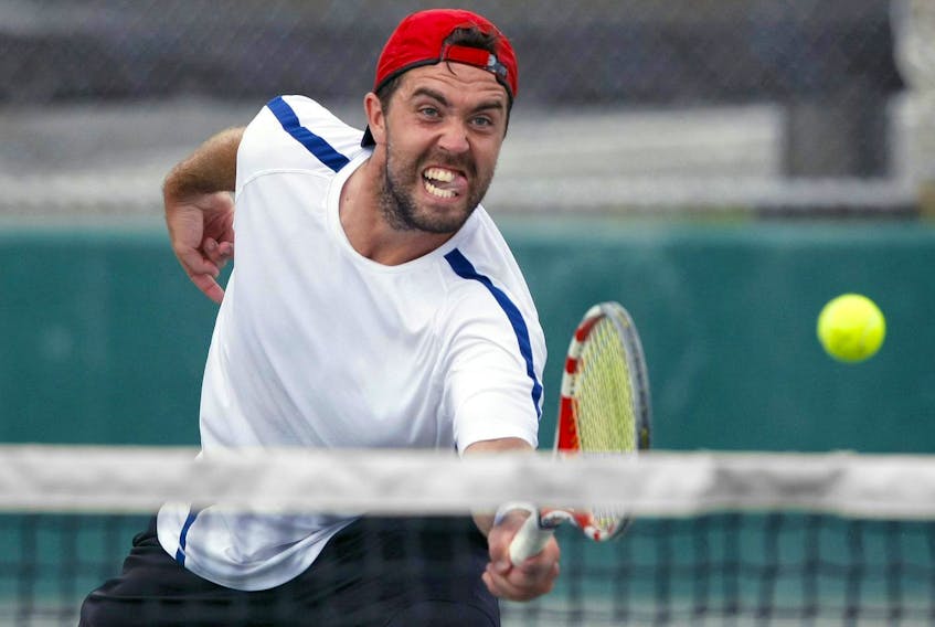 
Phil Anderson screams in to the net to return a volley from competitor Stefan Hall in the last set of the men’s quarter-finals of the the Gallagher Nova Scotia Open at the Waegwoltic Club on Aug. 30. The men’s first seed in the tournament beat Stefan Hall to take the game. - Eric Wynne
