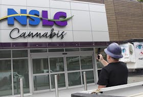 A contractor photographs the signage that his crew had just installed at the NSLC Cannabis outlet on Clyde Street in Halifax on Oct 1.