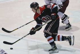 New Brunswick Reds forward Tyler Boland skates into the Saint Mary’s Huskies’ zone during an AUS hockey game on Nov. 30 at the Halifax Forum. Boland, in his second season with UNB, is second in conference scoring with 26 points in 18 games.