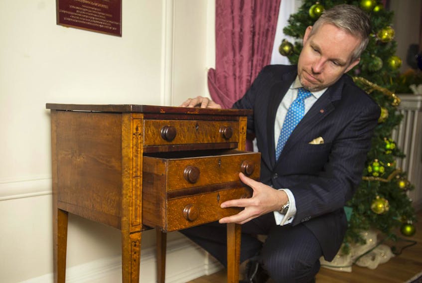 
Christopher McCreery, private secretary to the lieutenant-governor, shows a two-drawer Sheraton stand attributed to 19th-century Halifax cabinetmaker John Tulles. - Ryan Taplin 
