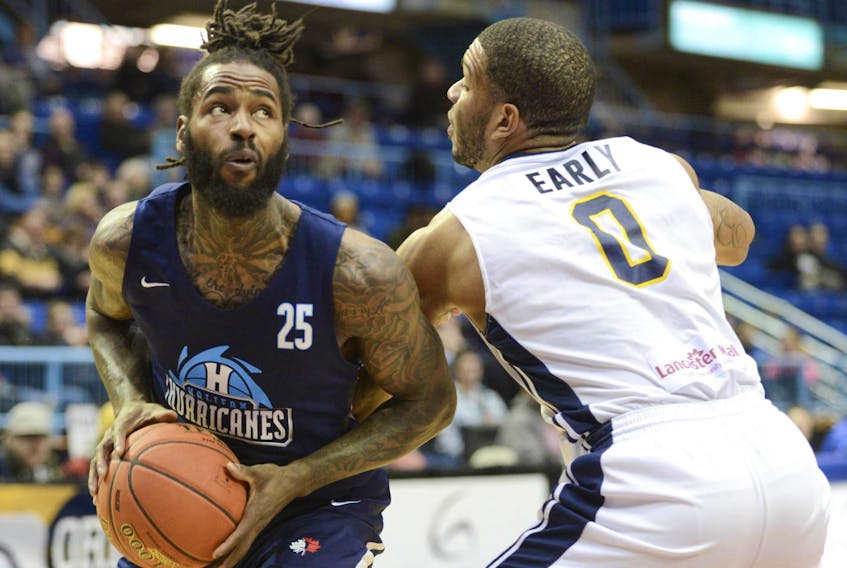 
Halifax Hurricanes’ Gabe Freeman, left, drives to the hoop against Saint John Riptides’ Chris Early during NBL of Canada action on Wednesday in Saint John. - Michael Hawkins
