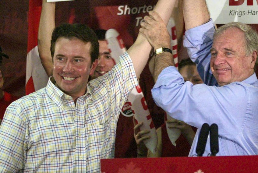
Former prime minister Paul Martin raises the arm of Liberal candidate Scott Brison during a 2004 campaign stop in Windsor. - Tim Krochak
