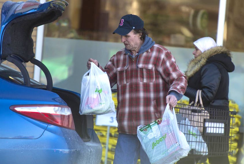 
A shopper loads grocery bags into a taxi at the Mumford Road Sobeys on Thursday. - Ryan Taplin
