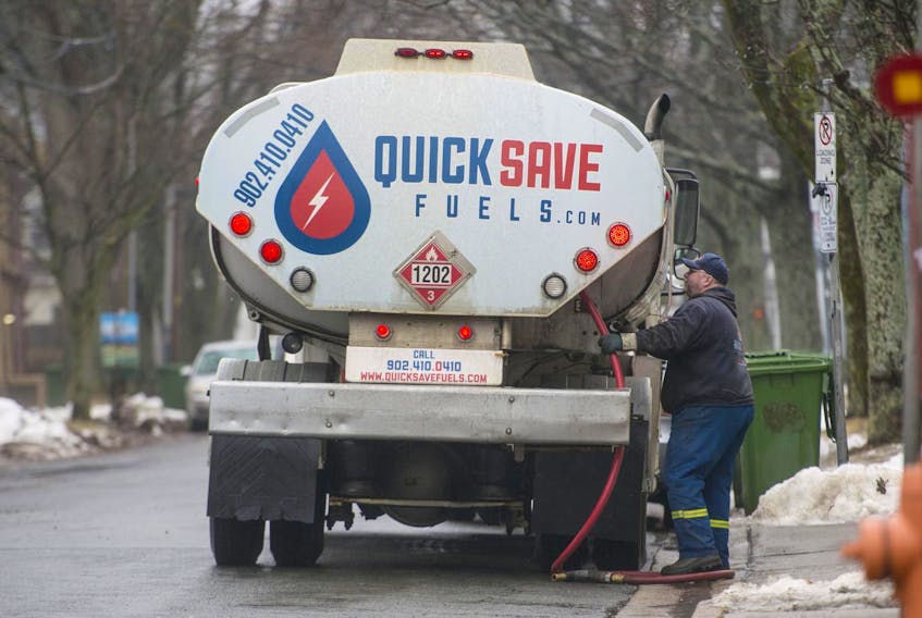 A fuel truck operator wraps up a delivery on Hunter Street in Halifax on Tuesday.