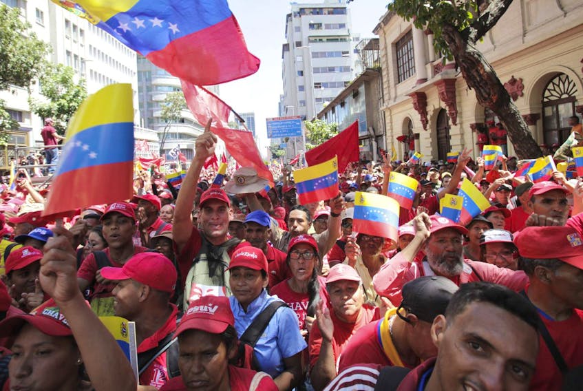 Supporters of President Nicolas Maduro cheer during a pro-government rally in Caracas, Venezuela, on Saturday. Maduro has closed Venezuela’s borders and calls humanitarian aid destined for Venezuela part of a U.S.-led coup.
