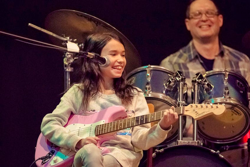 
Ava Calder performs on electric guitar at a recital at the Fall River School of Performing Arts. Calder has been a student at the school for three years. - Jen Donaldson
