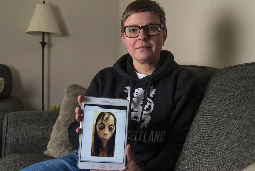 Gillian Robinson holds a tablet with an image associated with the Momo challenge at her Beaver Bank home. Her son, who is in Grade 3, is worried about seeing the image online.