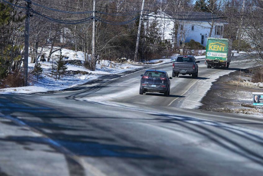 Vehicles pass through Harrietsfield on Old Sambro Road Thursday afternoon. The road was paved last year, however, MLA Brendan Maguire says the road has numerous potholes, cracks and dips. Maguire is asking for someone from the Transportation Department to take a look at the state of the road.