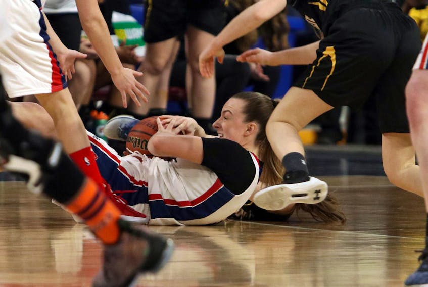 Acadia Axewomen’s Ellen Hatt looks for an open teammate after grabbing a loose ball on the floor in the first quarter of the AUS women’s basketball quarter-finals at the Scotiabank Centre on Friday afternoon.