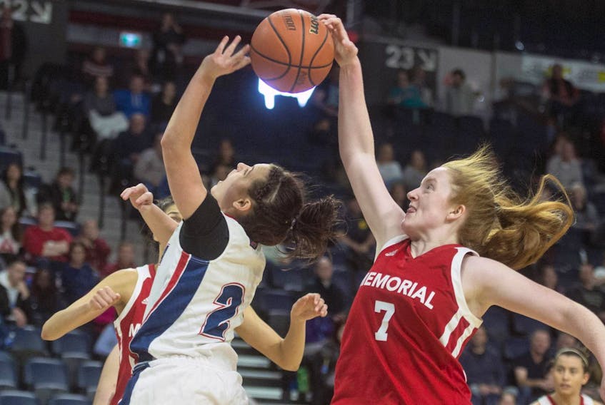 Memorial guard Alana Short blocks a shot from Acadia’s Haley McDonald during the second half of the AUS women’s basketball championship final at the Scotiabank Centre on Sunday afternoon.