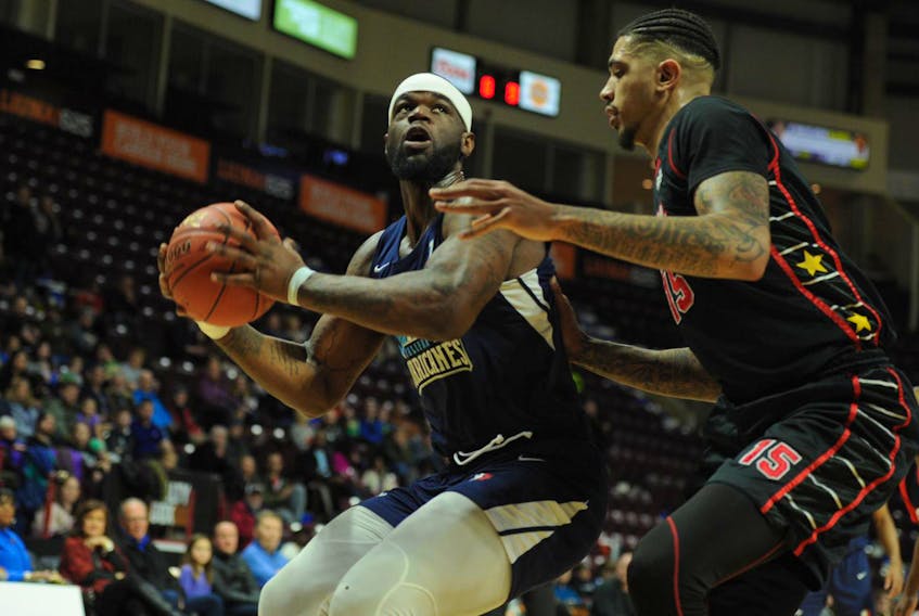
Hurricanes forward Chadrack Lufile eyes the basket while being guarded by the Express’ Ty Walker during NBL Canada action in Windsor on Wednesday night. The Express won the game 147-124. - Kevin Jarrold
