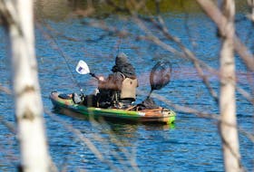 
A fisherman in a kayak spends time trying to get a nibble on Lake Banook on Wednesday. The lack of snow this winter doesn’t concern angler Larry Shortt, who works at Fishing Fever Fly and Tackle Shop. Eric Wynne THE CHRONICLE HERALD
