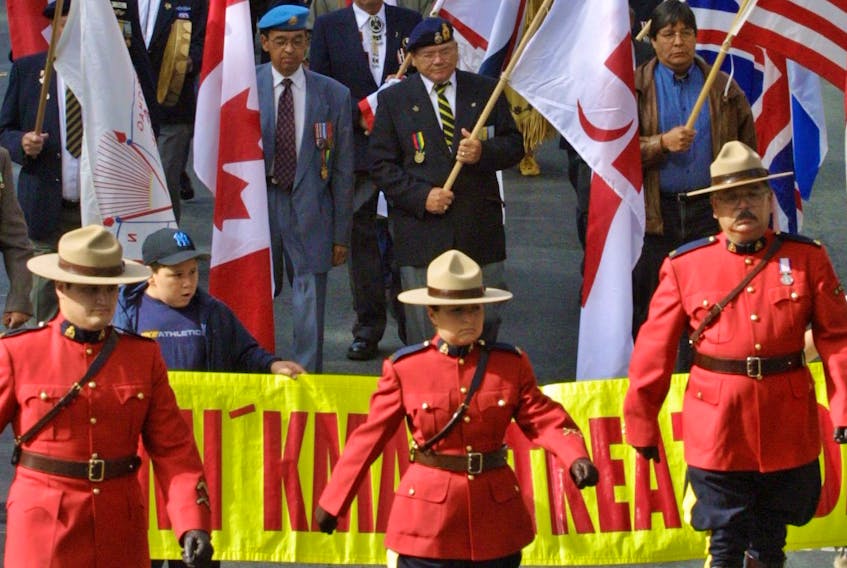 
RCMP officers lead a parade of Mi'kmaq veterans and supporters along Spring Gareden Road in Halifax on Monday. The event was part of Treaty Day celebrations. 
