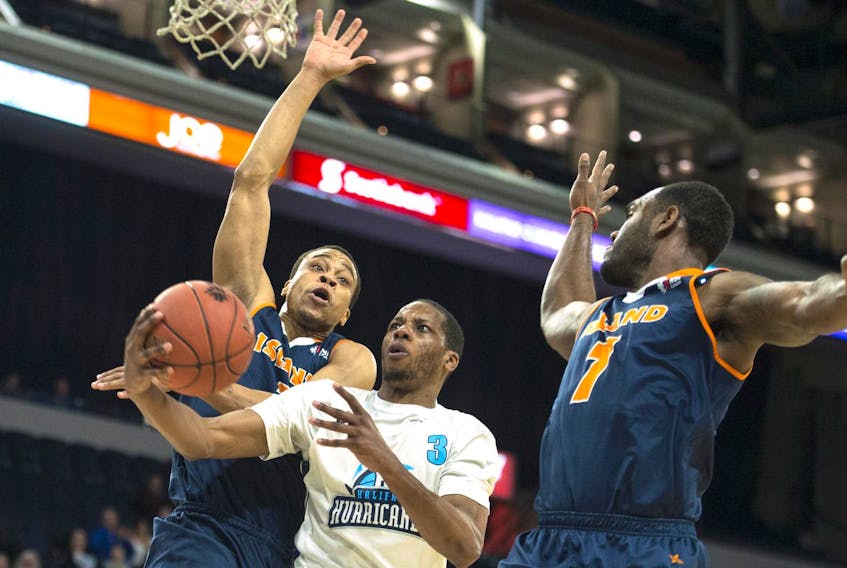 
Halifax Hurricanes forward Mike Poole tries to split through Island Storm defenders Tyree White, left, and Malik Story during the first half of Monday night’s NBL Canada game at the Scotiabank Centre. - Ryan Taplin, The Chronicle Herald
