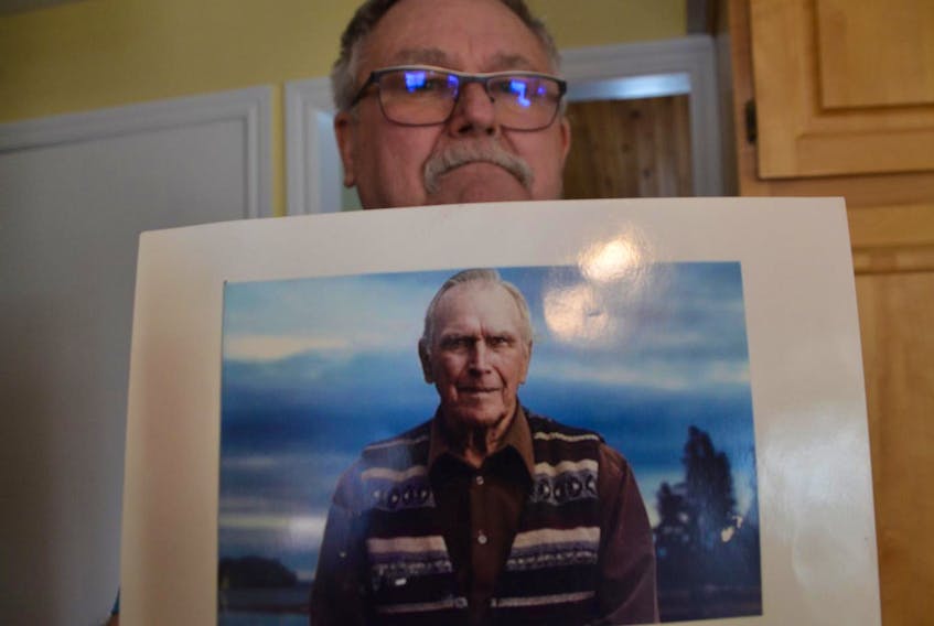 
David Blankenship holds a photo of his father, famed Oak Island treasure hunter Daniel Blankenship. - Aaron Beswick


