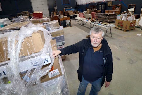 
Brian Barker, co-owner of Mariner Auctions, in his warehouse and live auction facility in Dartmouth. Auction houses have been changing in the past few years with the proliferation of online auctions instead of live auctions. - Eric Wynne
