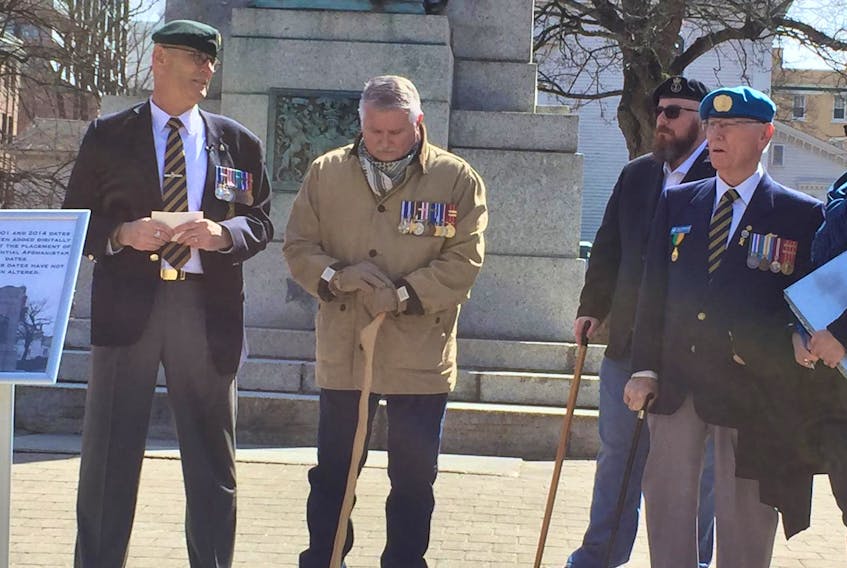 Retired army chief warrant officer Bob Thompson, left, chats with Canadian Armed Forces veterans and their supporters Sunday at a gathering meant to rally support for getting the years for Canada's presence in Afghanistan added to the front of the memorial cenotaph in Halifax's Grand Parade.