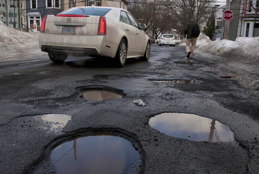 
Potholes begin with a crack in the pavement. The crack fills with water and, when it freezes, the water expands and opens the crack ever so slightly. It happens again and again, and the crack gets bigger and meaner. - File

