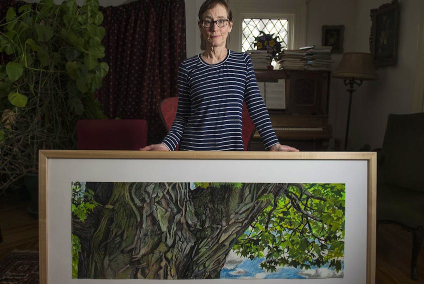 
Artist Hallie Watson poses for a photo at her Halifax home with one of her paintings called Maple Trunk with Sky. Watson’s show A Walk in the Woods opens at the Chase Gallery inside the Public Archives on April 5 and runs until April 30. 
