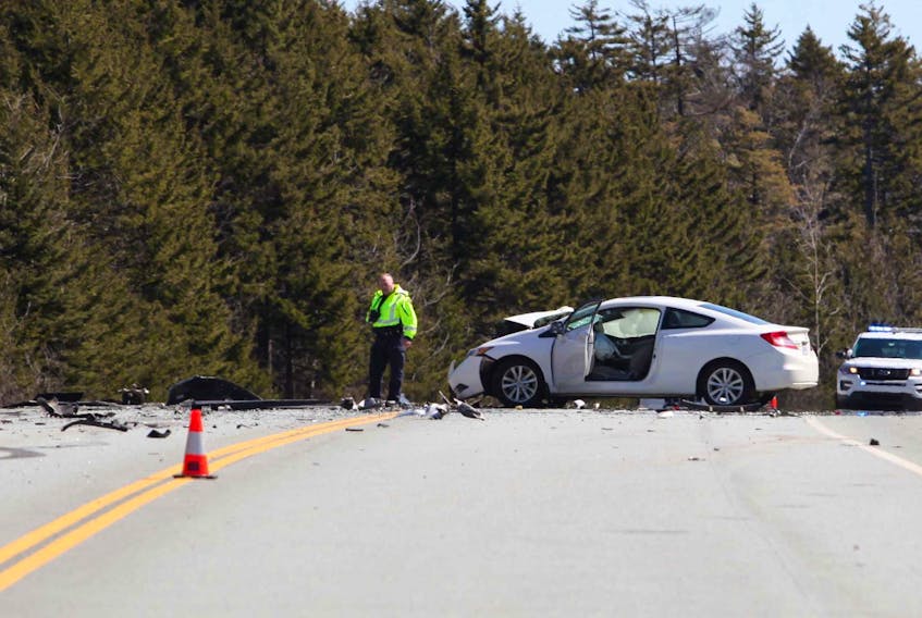 
An RCMP accident reconstruction specialist documents a three-vehicle accident on the Highway 107 extension in Dartmouth. - Eric Wynne
