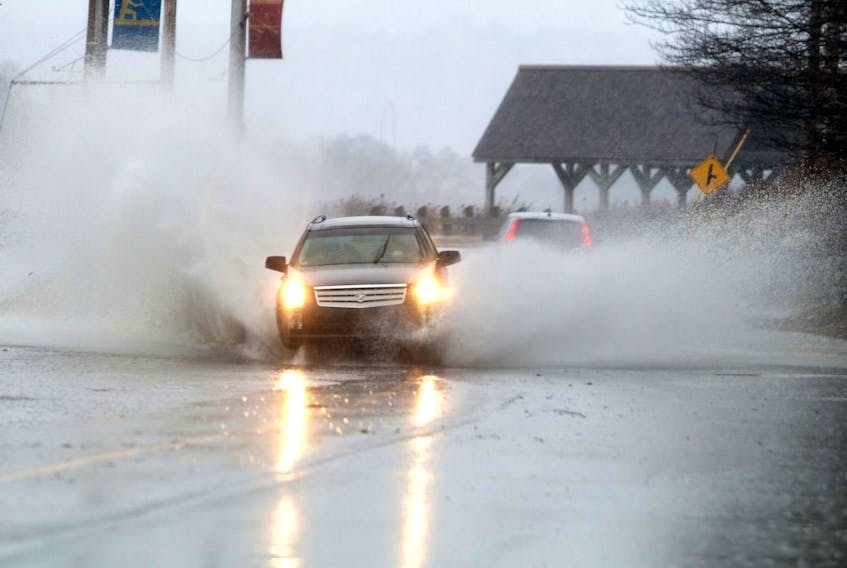 
A driver makes their way through water on Prince Albert Road in Dartmouth March 22. From shelburne to the Eastern Shore, 75 to 90 mm of rain are expected, and other less rainy areas may see flurries. - Eric Wynne 
