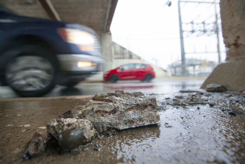 A piece of concrete sits on the Chebucto Road sidewalk just below the CN overpass.