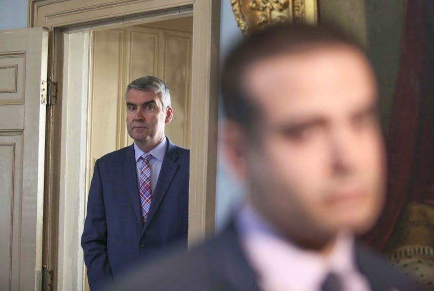 
Premier Stephen McNeil listens from the doorway of the Legislative Library on March 27 as Education Minister Zach Churchill speaks to the media about details of an incident he had with Conservative Leader Tim Houston. - Eric Wynne
